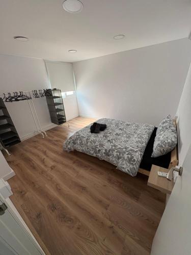 a bedroom with a bed and a wooden floor at Alma in La Canyera