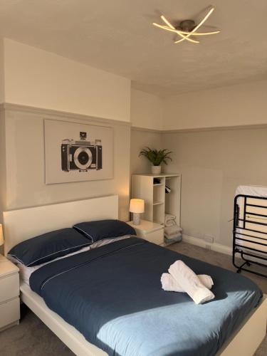 a bedroom with a bed with a camera on the wall at Cosy 2 Bed By Pleasure Beach in Blackpool