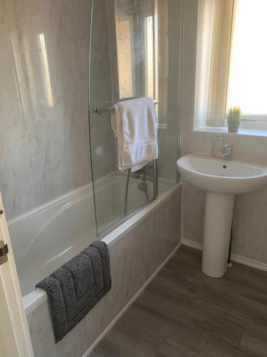a bathroom with a tub and a sink and a shower at Cosy 2 Bed By Pleasure Beach in Blackpool
