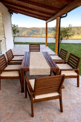 a wooden table and chairs on a patio at Casa indipendente con giardino e vista mare - Casa Gennaro in Agropoli