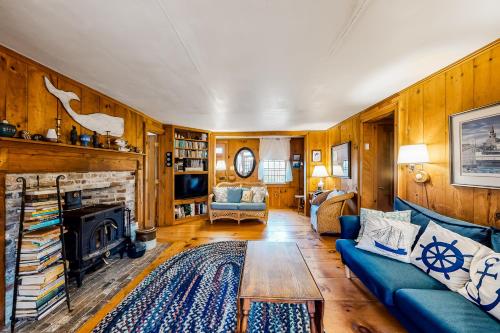 a living room with a blue couch and a fireplace at 1 Mi to Beach! Family-Friendly Nantucket Retreat in Nantucket