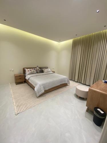 a bedroom with a bed and a large window at فلو بارك in Unayzah
