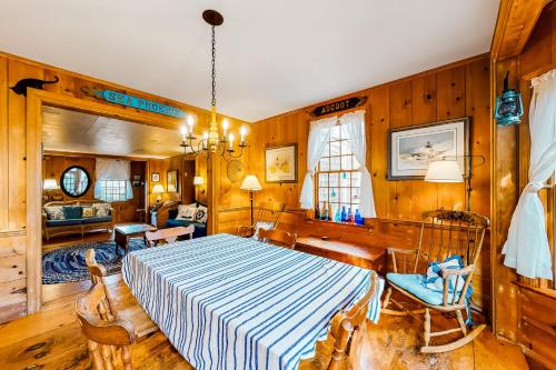 a bedroom with a large bed and wooden walls at 1 Mi to Beach! Family-Friendly Nantucket Retreat in Nantucket