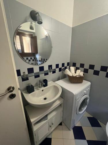 a bathroom with a sink and a washing machine at Garden Prina-250mt Clinica Zucchi-Monza in Monza