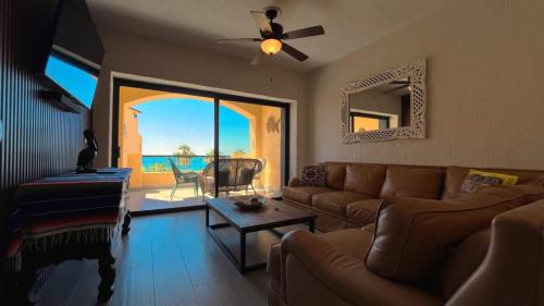 a living room with a couch and a view of the ocean at Gorgeous Third-Level Condo Princesa D-308 in Puerto Peñasco