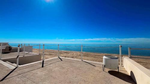 a view of the beach from the balcony of a house at Charming and Cozy Beachfront Condo - Las Olas II 3 in Puerto Peñasco