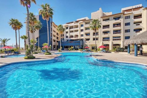 a large swimming pool in front of a hotel at Cozy Ground Level Condo near Pool Pinacate 112 in Puerto Peñasco
