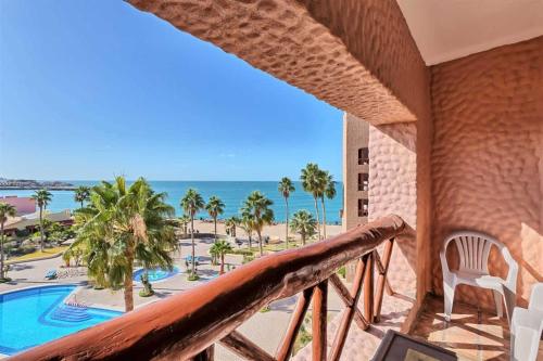 a balcony with a view of the beach and the ocean at Charming Condo in Great Location Pinacate 412 in Puerto Peñasco