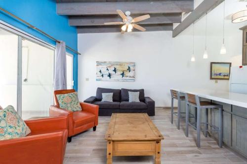 a living room with two chairs and a table at Cozy & Beautiful Beachfront Condo Las Olas II 2 in Puerto Peñasco