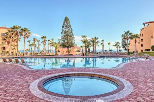 a swimming pool with a christmas tree and palm trees at Gorgeous Third-Level Condo Princesa D-308 in Puerto Peñasco