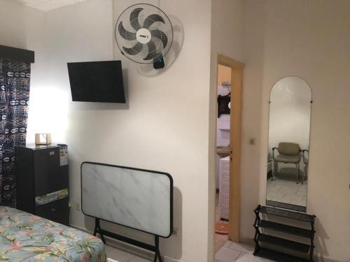 a bedroom with a bed and a mirror on the wall at Chambre indépendante in Port-Gentil