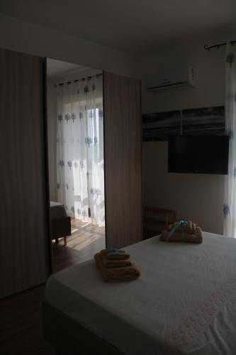 a bedroom with a bed with towels on it at Tropical House in Formia