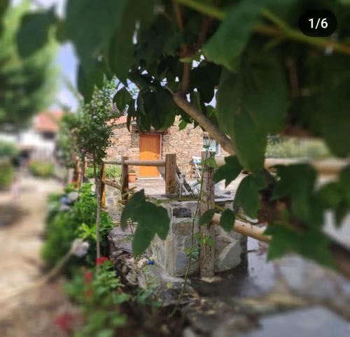 a garden with a fence and a brick building at Casa da Eira in Pinheiro de Coja