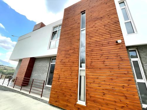 a wooden wall on the side of a building at Farka Lake Luxury Villa in Tirana