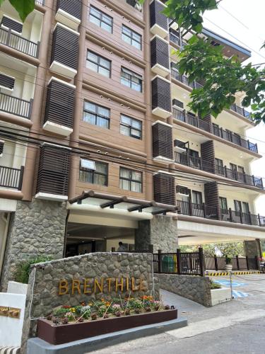 a large building with a sign in front of it at La Montañosa at Brenthill Baguio Condo near City Center in Baguio