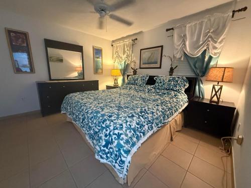 a bedroom with a bed with a blue comforter at Bimini Paradies South Bimini North Bimini Bahamas Bimini 10B Alice Town in South Bimini