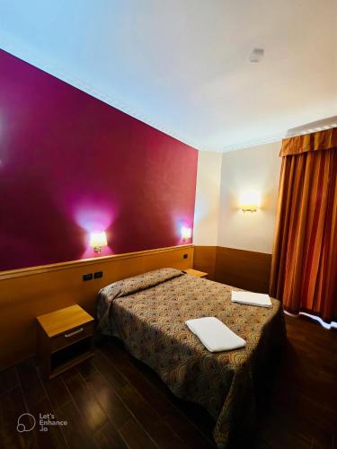 a hotel room with a bed with a laptop on it at Beauty Rooms in Rome