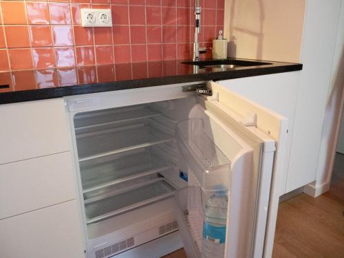 a refrigerator with its door open in a kitchen at AzoreanStar Accommodations in Ponta Delgada