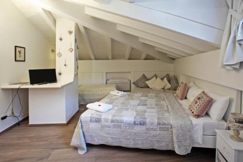 a bedroom with a large bed and a couch at Villa Giuliana - Attic apartment in Menaggio
