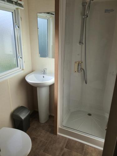 a bathroom with a shower and a sink at Rockley Park, Poole, 3 Bedroom Family Retreat in Poole in Poole