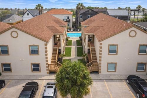 an apartment complex with cars parked in a parking lot at Swanky 2 Bedroom, Easy Walk to Beach Mar y Sol II # 1 in South Padre Island