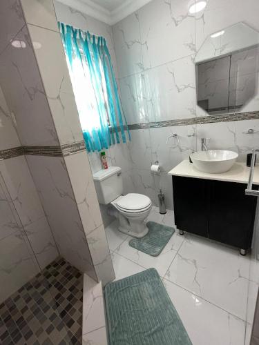a bathroom with a toilet and a sink at Casa de Marcos in Swakopmund