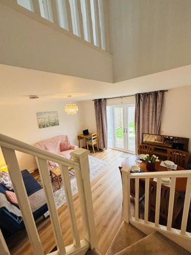 a large living room with a staircase and a living room at Penuel 3-bedroom Retreat with workspace in Central Sutton-in-Ashfield in Sutton in Ashfield
