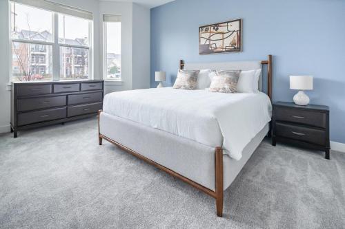 a bedroom with a large white bed and a window at Landing Beautiful 2BD in Lees Summit in Lees Summit