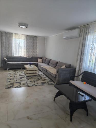 a living room with a couch and a table at Ariona apartment in Draç