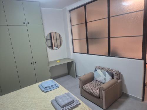 a small room with a chair and a table at Casa Via Egnatia in Komotini