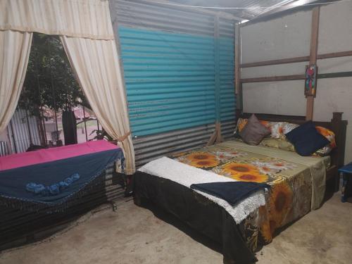a bedroom with a bed and a window at Casa de playa MC in Quepos