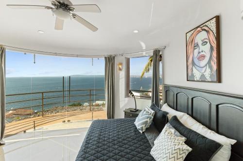 a bedroom with a bed and a view of the ocean at Luxe 3 King BR Villa | Infinity Pool + 220° Views in Puerto Vallarta