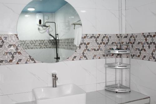 a bathroom with a sink and a mirror at Ocean Echo Villa in Mathiveri