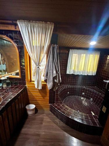a bathroom with a tub and a window at Rustic Escape Between Valle & Avándaro in Valle de Bravo