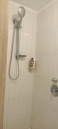 a shower with a shower head in a bathroom at Sun Terrace Sorrento in Sorrento