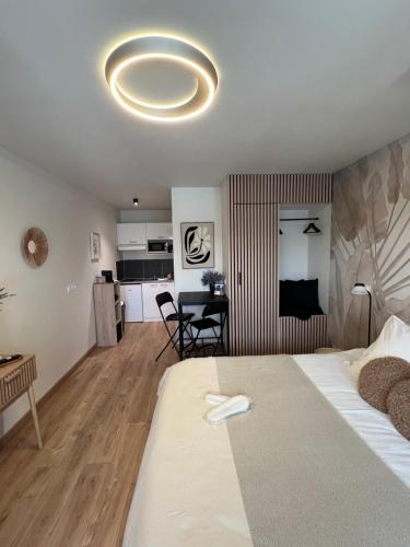 a bedroom with a large bed and a living room at Luméa 126 in Éguilles