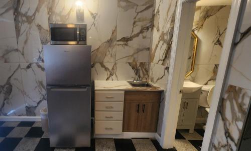 a small kitchen with a refrigerator and a sink at E & E Motel in Myrtle Beach