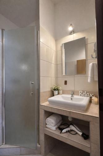 a bathroom with a sink and a shower at Penzion u Fouska in Chodov
