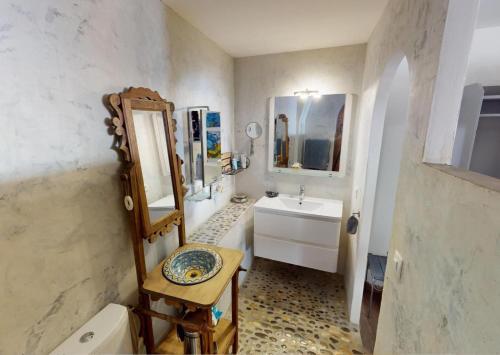 a bathroom with a sink and a mirror at Sunset lodge in Bouzigues