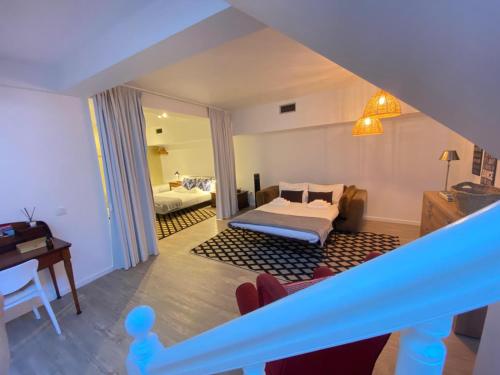 a view of a bedroom with a bed and a living room at CHC Rochinha Studio in Funchal