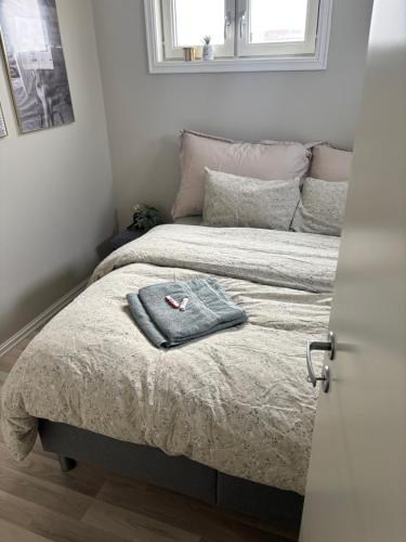 a bedroom with a bed with a towel on it at Casa Brekka in Bamble
