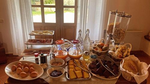 a table with many plates of food on it at 8380 Agriturismo il Saragiolo in Manciano