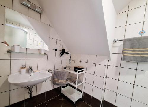 a white bathroom with a sink and a mirror at Špirala place - near city center, free parking in Bled