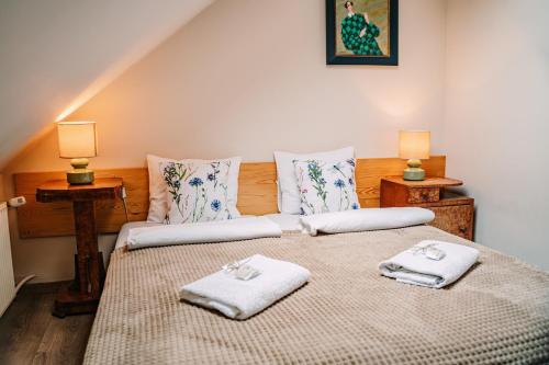 a bedroom with a large bed with towels on it at Willa tuŻur in Osie