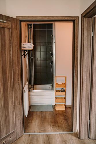 an open door to a bathroom with a shower at Willa tuŻur in Osie