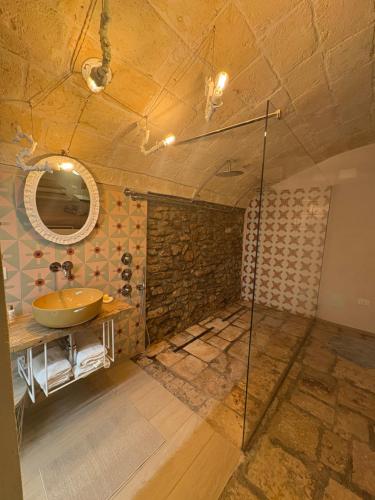 a bathroom with a sink and a mirror at Il Cuore di San Cipriano in Mesagne