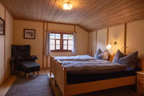 a bedroom with a bed and a chair at  