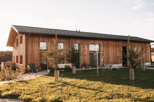 a wooden house with a yard in front of it at Individual room surrounded by nature in Sankt Georgen bei Salzburg