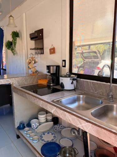 a kitchen with a sink and a counter with dishes at Marea Azul Guanacaste in Puerto Soley