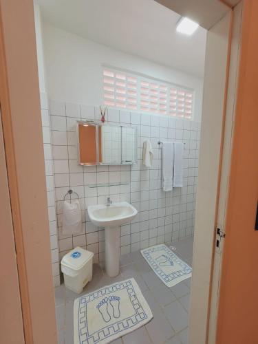 a bathroom with a sink and a toilet at Hotel Pousada Cachalote in Coruripe